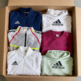Open box of new-with-tags Adidas jackets and sweatshirts